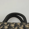 Close-up of the handles of a vintage Dior Boston Bag made from navy Trotter Canvas.