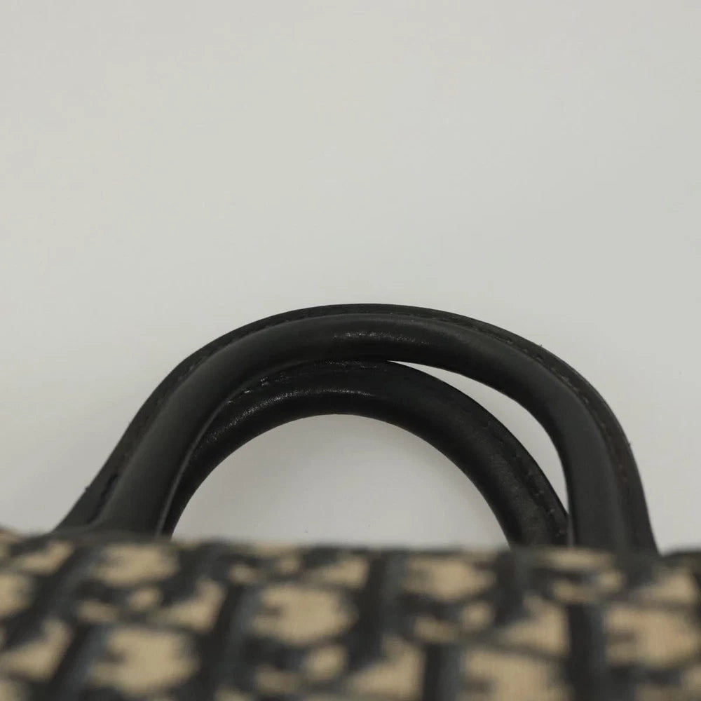 Close-up of the handles of a vintage Dior Boston Bag made from navy Trotter Canvas.