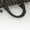 Close-up of the handle of a vintage Dior Boston Bag in navy Trotter Canvas, showcasing its design and quality.